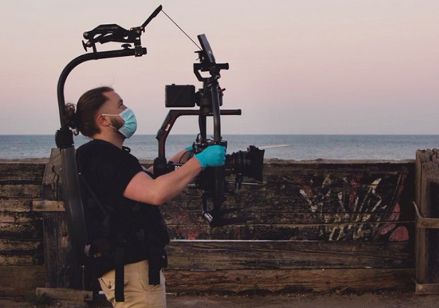 Camera man with gimbal ans screens and masked